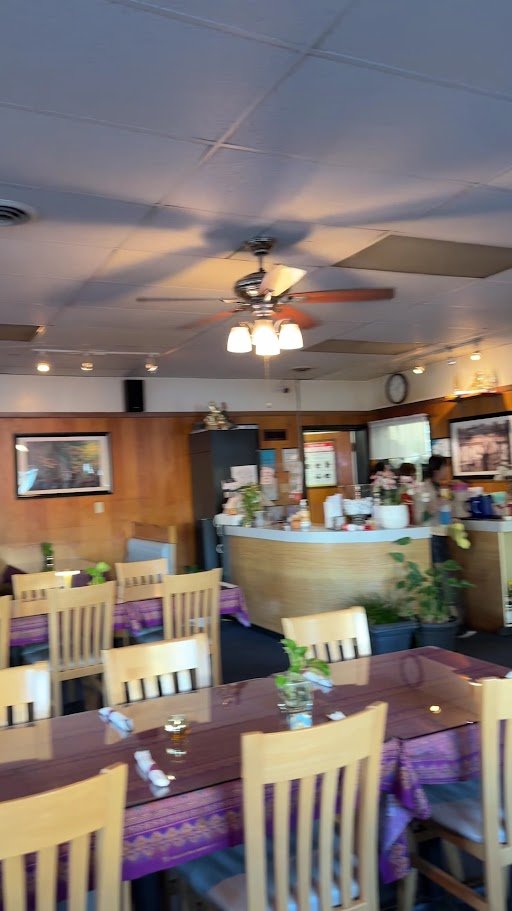 Traditional Thai restaurant interior with warm, modest decor.